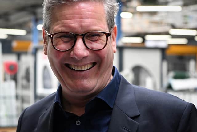 Keir Starmer is all smiles on a visit to Whitburn but Labour faces a tough task in government (Picture: Andy Buchanan/AFP via Getty Images)