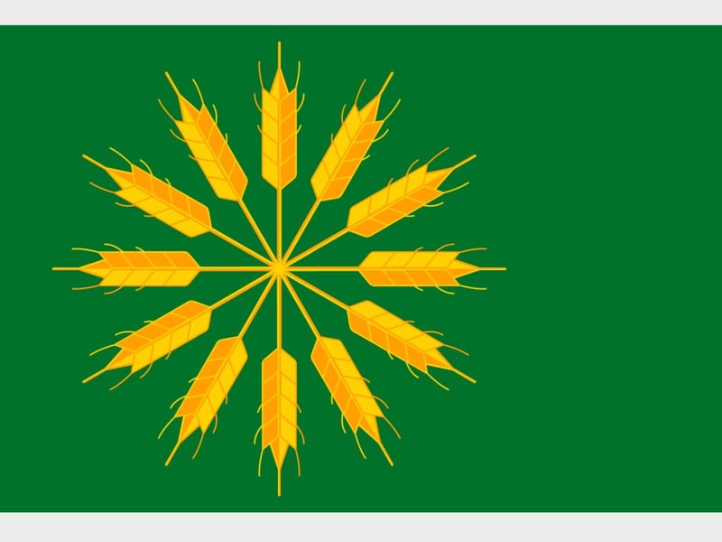 The Isle of Tiree is the most westerly island of the Inner Hebrides. The green colour represents the fertility of the isle while the barley stalks refer to the name of this location 'Land of Barley' (Tìr an Eòrna) - this flag dates to 2018.