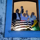 Brazilian former president and presidential candidate for the leftist Workers Party (PT), Luiz Inacio Lula da Silva (R), speaks to supporters holding hands with Sao Paulo Governor candidate Fernando Haddad (L), and Brazil's vice-presidential candidate Geraldo Alckmin.