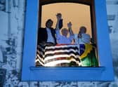 Brazilian former president and presidential candidate for the leftist Workers Party (PT), Luiz Inacio Lula da Silva (R), speaks to supporters holding hands with Sao Paulo Governor candidate Fernando Haddad (L), and Brazil's vice-presidential candidate Geraldo Alckmin.
