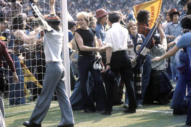 Scotland fans celebrate on the pitch after their team's victory at Wembley in 1977.