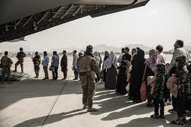 Evacuees wait to board a Boeing C-17 Globemaster III during an evacuation at Hamid Karzai International Airport in Kabul, Afghanistan. Picture: Staff Sgt. Victor Mancilla/U.S. Marine Corps via AP, File