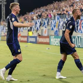 Scotland's Ryan Porteous celebrates with the Tartan Army after scoring against Cyprus.