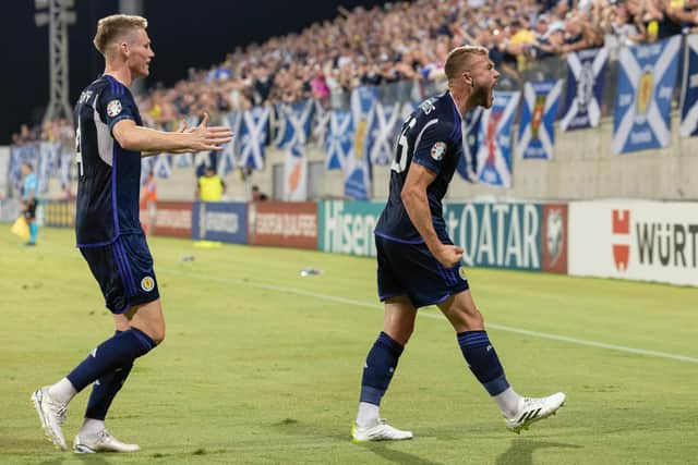 Scotland's Ryan Porteous celebrates with the Tartan Army after scoring against Cyprus.