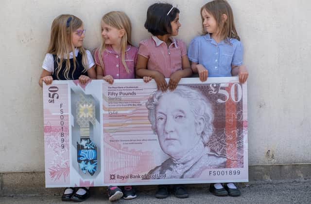 Pupils from Flora Stevenson Primary School in Edinburgh with the design for the bank's new £50 note which features an illustration of Scottish education pioneer Flora Stevenson (Photo: Royal Bank of Scotland/PA Wire).