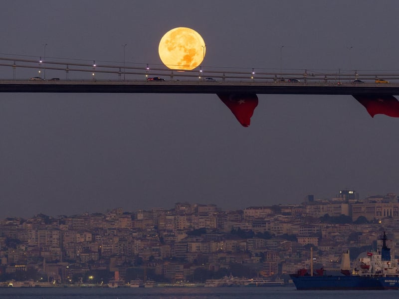 Cars drive across the July 15 Martyrs Bridge (Bosphorus Bridge) as the rare Super Blue Moon sets behind in Istanbul, Turkey. (Photo by Chris McGrath/Getty Images)