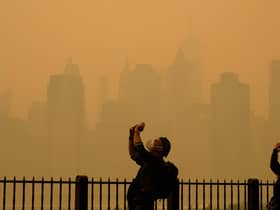 People take photos of the sun as smoke from the wildfires in Canada cause hazy conditions in New York City. Picture: Angela Weiss/AFP via Getty Images