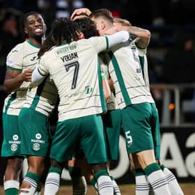 Hibs' Lewis Miller (C) celebrates scoring to make it 2-0 with his teammates at Dundee.