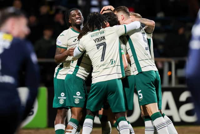 Hibs' Lewis Miller (C) celebrates scoring to make it 2-0 with his teammates at Dundee.