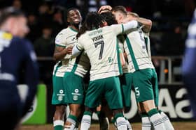 Hibs' Lewis Miller (C) celebrates scoring to make it 2-0 with his teammates at Dundee.