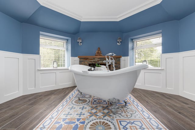 The detailed tiles and free-standing bath are the perfect place to unwind in