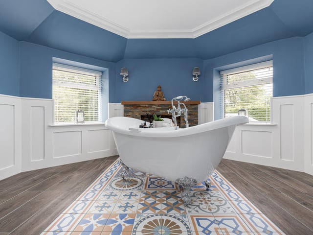 The detailed tiles and free-standing bath are the perfect place to unwind in