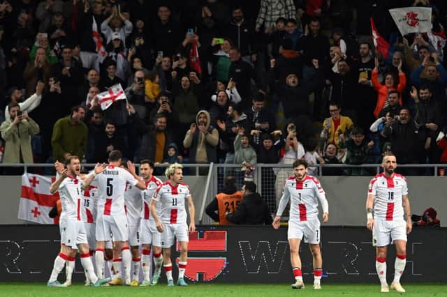 Georgia's players celebrate their equaliser.