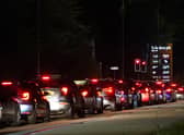 Motorists queue to fill their cars at a Sainsbury's fuel station in Ashford, Kent.
