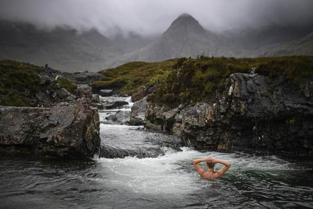 A swimmer in the Fairy Pools, Glenbrittle on the Isle of Skye. PIC Jeff J Mitchell/Getty Images