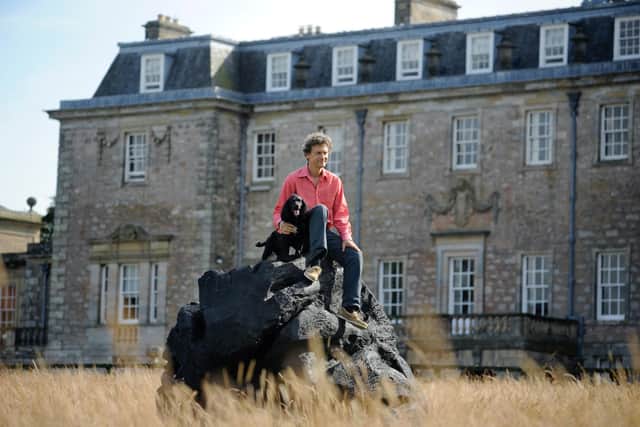 The late Hugo Burge at Marchmont House in the Borders with a sculpture made out of burnt oak. Photo: Colin Hattersley.