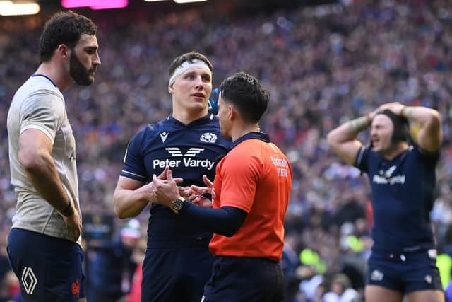 Referee Nic Berry explains his no try decision, after a TMO review, to Charles Ollivon of France and Rory Darge of Scotland in the final minute of the Guinness Six Nations 2024 match at Murrayfield. (Photo by Stu Forster/Getty Images)