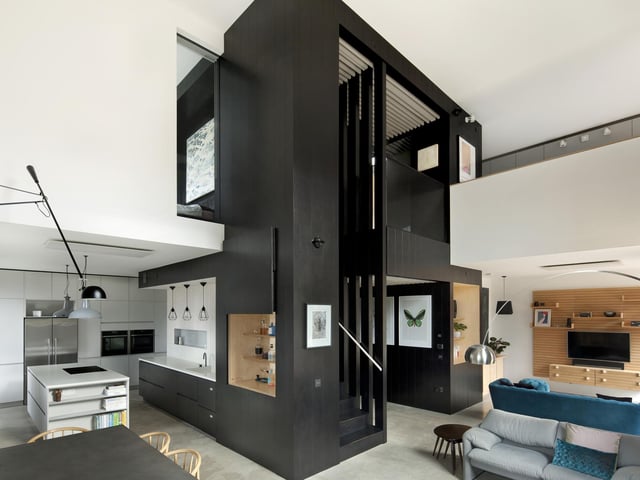 With the kitchen and living spaces pushed to the outer edges of the home, the home has a cubic core which houses a bathroom, three bedrooms and an office. It also has an emphasis on sustainability and the environment with windows capitalising on solar heat energy.