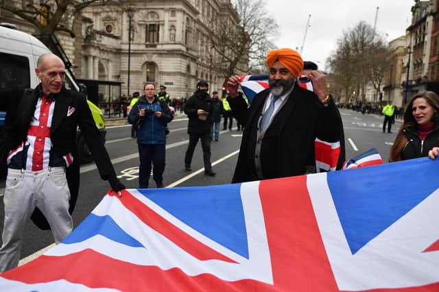 Pro-Brexit supporters wave Union Jack flags in London's Parliament Square ahead of the UK's depature from the EU on January 31 this year (Picture: Jeff J Mitchell/Getty Images)