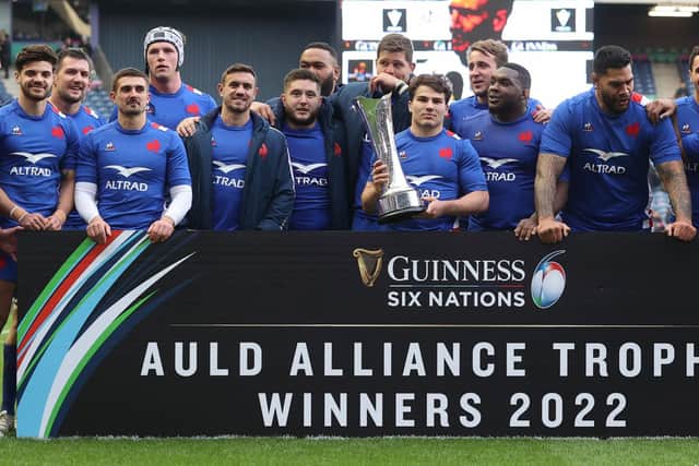 France's Antoine Dupont lifts the Auld Alliance Trophy at full time.