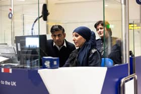Prime Minister Rishi Sunak looks at the passport control unit next to Border Force officer Samira Bazzar at Gatwick Airport. Picture: Carlos Jasso - WPA Pool/Getty Images
