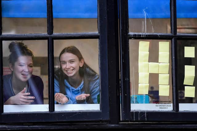 Students from Glasgow University look out the windows of accommodation at Murano Street student village (Picture: Jeff J Mitchell/Getty Images)