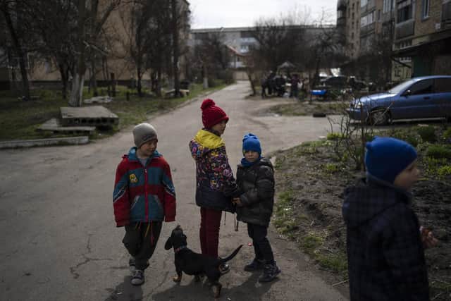 Children walk in Bucha on the outskirts of Kyiv, Ukraine, Friday, April 8, 2022.  (AP Photo/Rodrigo Abd, File)