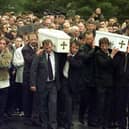 The three coffins of brothers Richard, Mark and Jason Quinn being carried by family and mourners to Rasharkin Church for burial after leaving funeral mass at the Church of  Our Lady and St Patricks, Ballymoney. Picture: Press Association