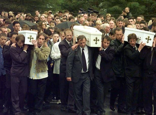 The three coffins of brothers Richard, Mark and Jason Quinn being carried by family and mourners to Rasharkin Church for burial after leaving funeral mass at the Church of  Our Lady and St Patricks, Ballymoney. Picture: Press Association