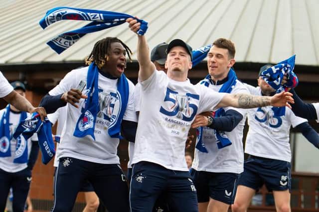 Ryan Kent (centre) celebrates with team-mates Calvin Bassey (left) and Ryan Jack (right) on the day Rangers clinched the Premiership title. (Photo by Ross MacDonald / SNS Group)