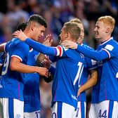 Rangers' Robbie Ure (left) celebrates with his team-mates after scoring their side's first goal of the game during the Premier Sports Cup second round match at the Ibrox against Queen of the South.