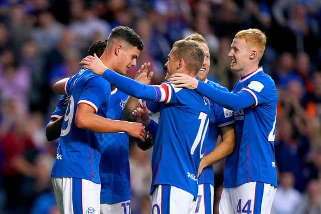 Rangers' Robbie Ure (left) celebrates with his team-mates after scoring their side's first goal of the game during the Premier Sports Cup second round match at the Ibrox against Queen of the South.