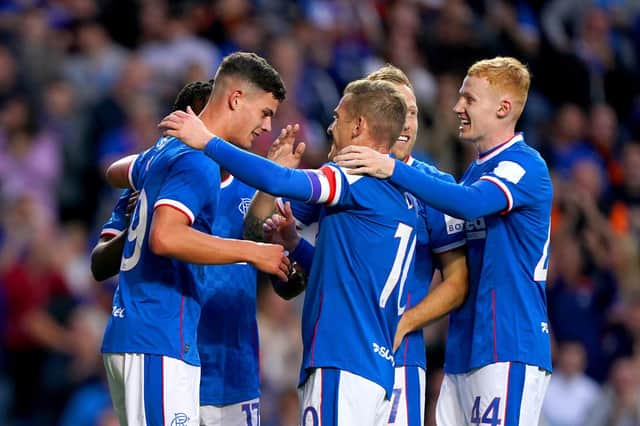Rangers' Robbie Ure (left) celebrates with his team-mates after scoring their side's first goal of the game during the Premier Sports Cup second round match at the Ibrox against Queen of the South.