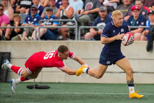 Arron Reed of Scotland scores a try as Cooper Coats of Canada tries to tackle him in the second half of Scotland's 73-12 win. (Photo by Chris Tanouye/Getty Images for Scottish Rugby)