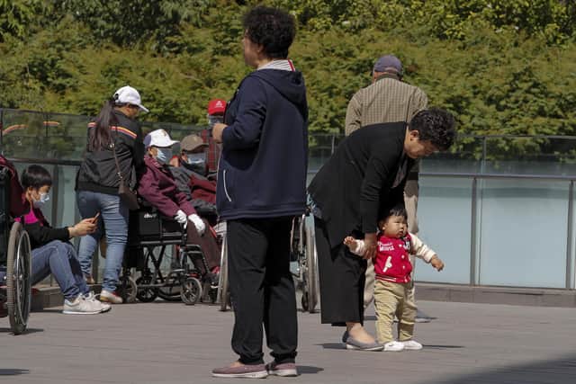 China's ruling Communist Party will ease birth limits to allow all couples to have three children instead of two to cope with the rapid rise in the average age of its population. (AP Photo/Andy Wong)