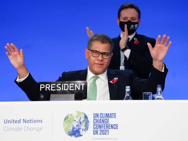 Alok Sharma, President of the COP26 climate summit, raises his hands after his speech of the closing plenary, during an 'overun' day of the summit in Glasgow on Saturday. Photo: Jane Barlow/PA Wire