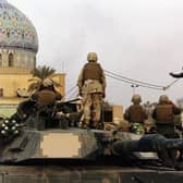 A statue of Iraqi dictator Saddam Hussein is toppled at al-Fardous Square in Baghdad, Iraq, in April 2003 (Picture: Wathiq Khuzaie/Getty Images)