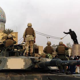 A statue of Iraqi dictator Saddam Hussein is toppled at al-Fardous Square in Baghdad, Iraq, in April 2003 (Picture: Wathiq Khuzaie/Getty Images)