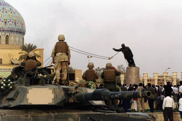 A statue of Iraqi dictator Saddam Hussein is toppled at al-Fardous Square in Baghdad, Iraq, in April 2003 (Picture: Wathiq Khuzaie/Getty Images)