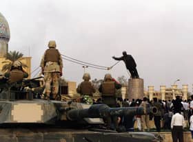 A statue of Iraqi dictator Saddam Hussein is toppled at al-Fardous Square in Baghdad, Iraq, in April 2003 (Picture: Wathiq Khuzaie/Getty Images)