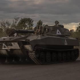 A Ukrainian serviceman drives a self-propelled howitzer 2S1 Gvozdika in the Sumy region, near the border with Russia, on August 13
