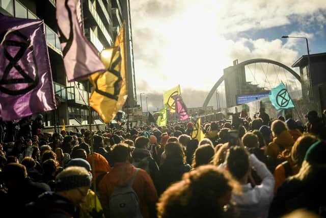 Extinction Rebellion protesters gathered outside the entrance to the COP26 site on Friday.