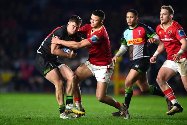 Cameron Anderson of Harlequins is tackled by Shay McCarthy of Munster during a friendly.