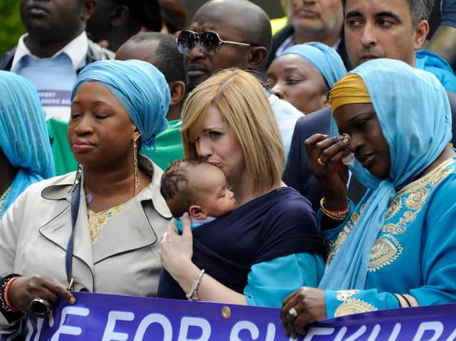 Sheku Bayoh's partner Collette kisses their baby's head during the funeral procession.