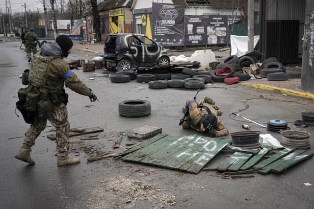 A Ukrainian servicemen check streets for booby traps in the formerly Russian-occupied Kyiv suburb of Bucha, near Kyiv. As Russian forces pull back from Ukraine's capital region, retreating troops are creating a "catastrophic" situation for civilians by leaving mines around homes, abandoned equipment and "even the bodies of those killed," President Volodymyr Zelenskyy has warned Saturday.