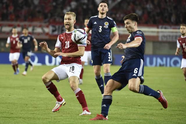 Austria's midfielder Konrad Laimer and Scotland's defender Kieran Tierney vie for the ball.