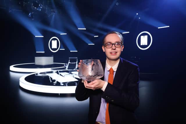 Glasgow student Jonathan Gibson, aged 24, shows off the coveted Caithness Glass trophy after becoming the youngest ever winner of Mastermind