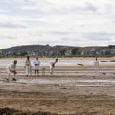 A bowler delivers a ball from the sea end in the photograph of cricket on the beach at Elie that so impressed a reader (Picture: Cath Ruane)