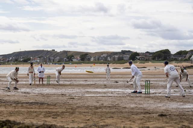 A bowler delivers a ball from the sea end in the photograph of cricket on the beach at Elie that so impressed a reader (Picture: Cath Ruane)