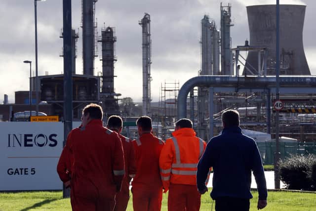Workers walk through the Grangemouth oil refinery. Picture: PA